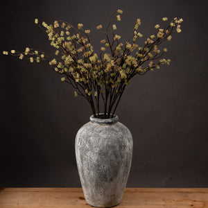 Harvey Bruce artificial branch filler for vases in a decorative gray vase enhancing home decor