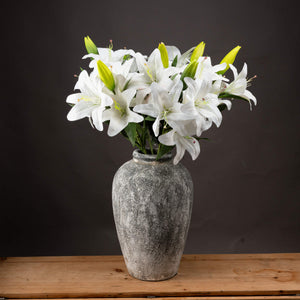 Artificial white lily arrangement in a textured gray vase for elegant home decor