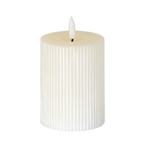 Textured ribbed LED candle in white, ideal for creating a warm ambiance in any space